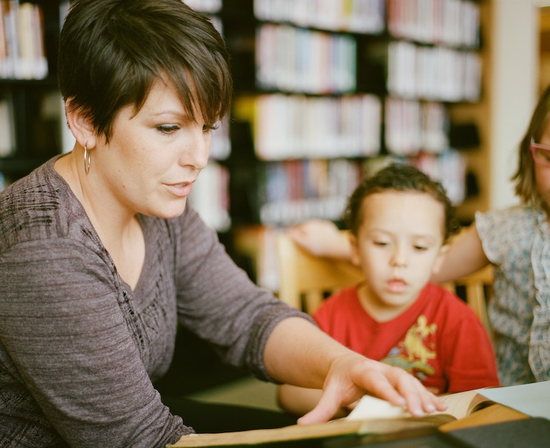 A woman tutoring a young child