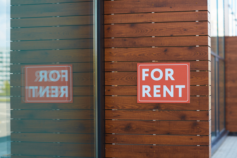 A Red sign that reads "For Rent"