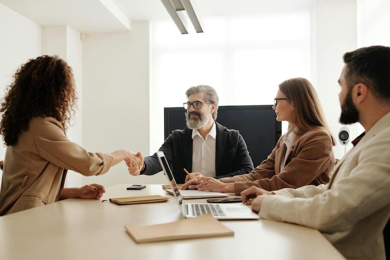 nonprofit leaders shaking hands after agreeing to nonprofit collaboration