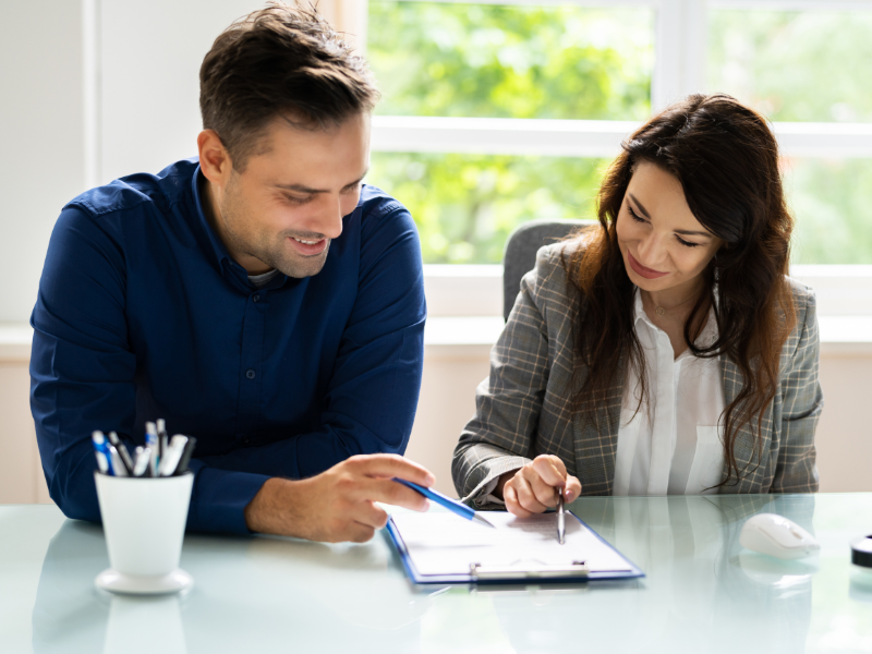 A man and a woman looking over a contract for nonprofits