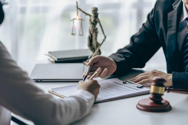 Nonprofit leader reviewing legal documents with an attorney.