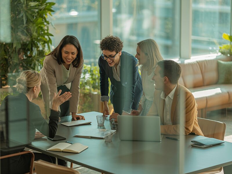 A group of people meeting in a modern office to discuss payroll for nonprofits