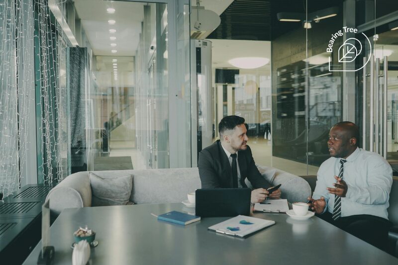 An image showing a man meeting with a representative from a professional employer organization for nonprofits