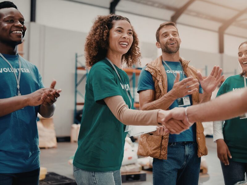 Nonprofit workers shaking hands as they receive funding from a nonprofit supporting organization